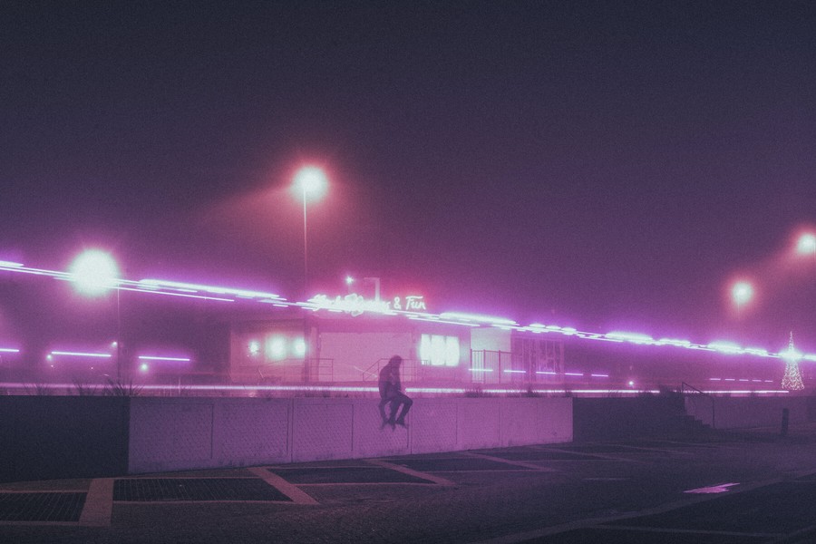 man sitting on a small wall